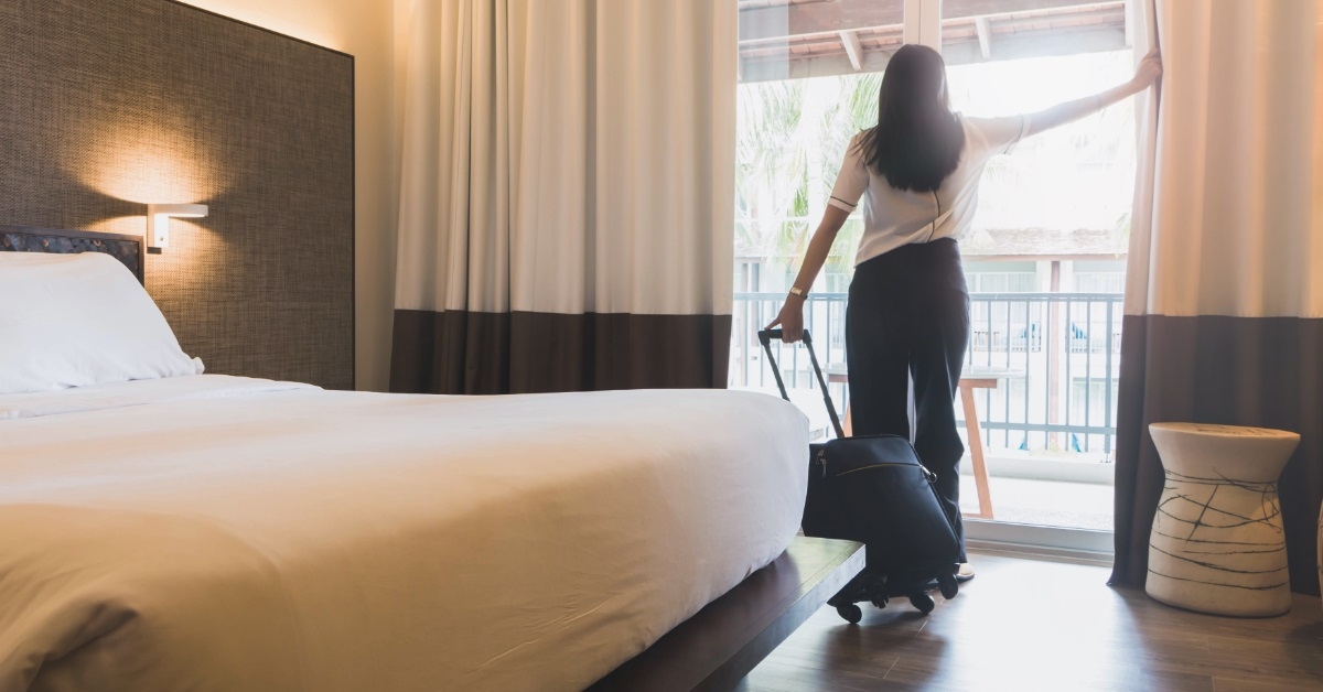 Woman checking out hotel room