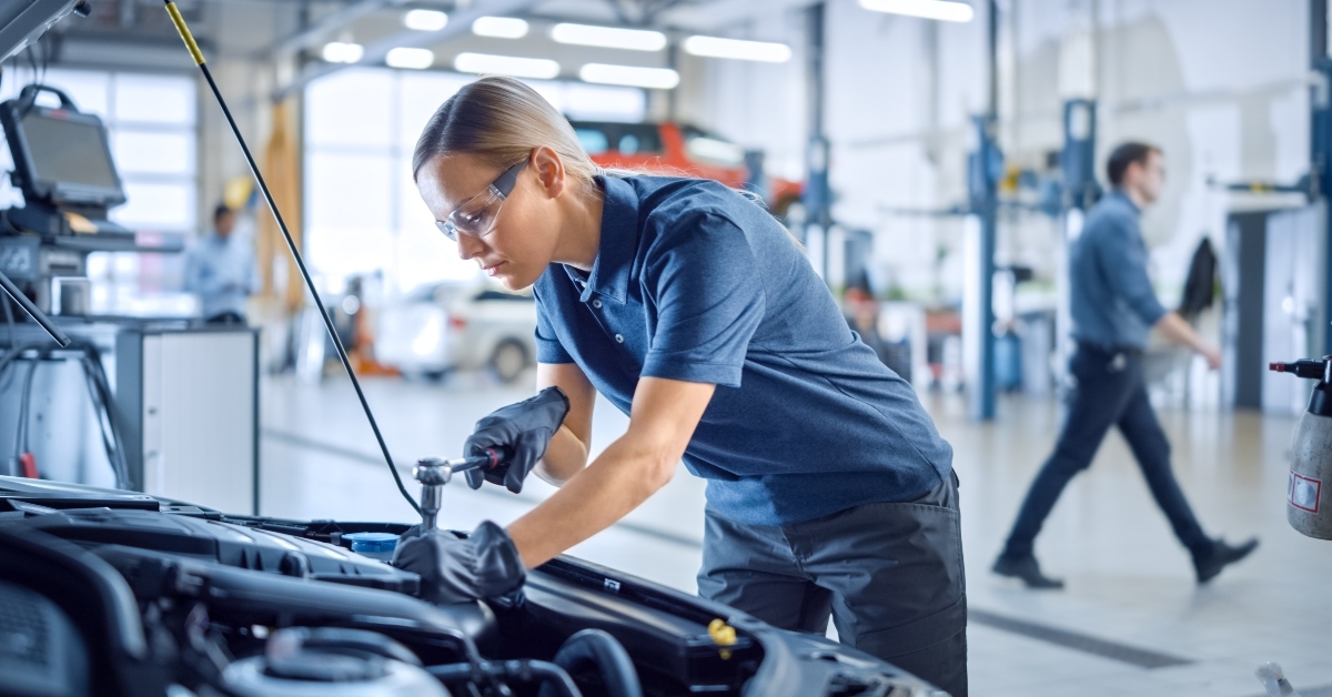 Female mechanic working on a car