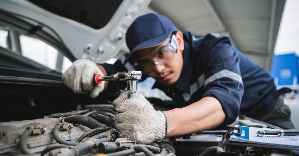 A mechanic repairing an engine