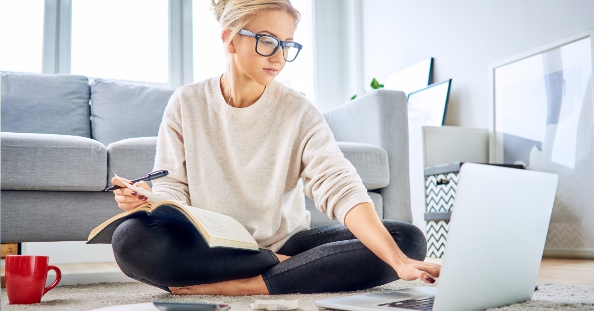 Young woman paying bills using laptop