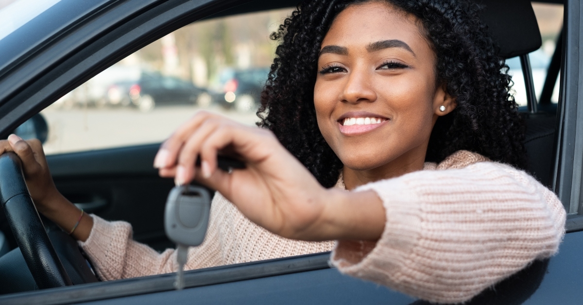 young woman learning to drive car