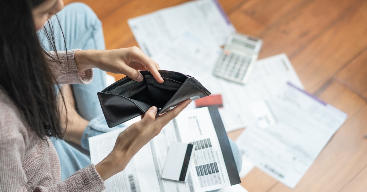 woman opens empty wallet