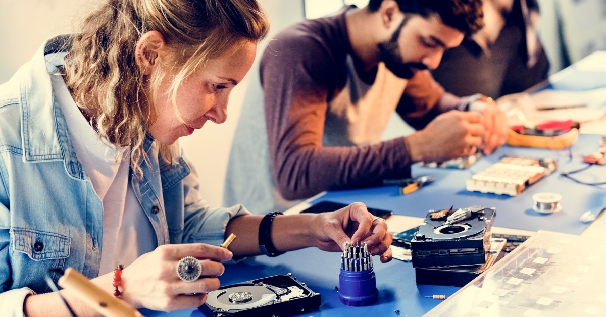 electrical technicians working on computer parts
