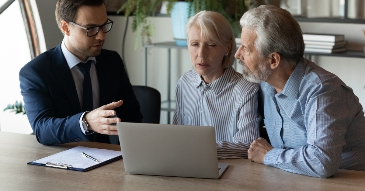 couple discussing wills with lawyer