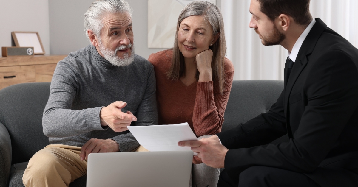 Insurance agent consulting elderly couple