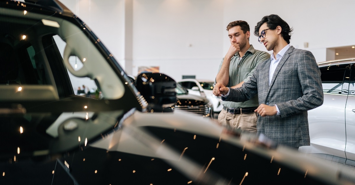 car dealer showing car to client