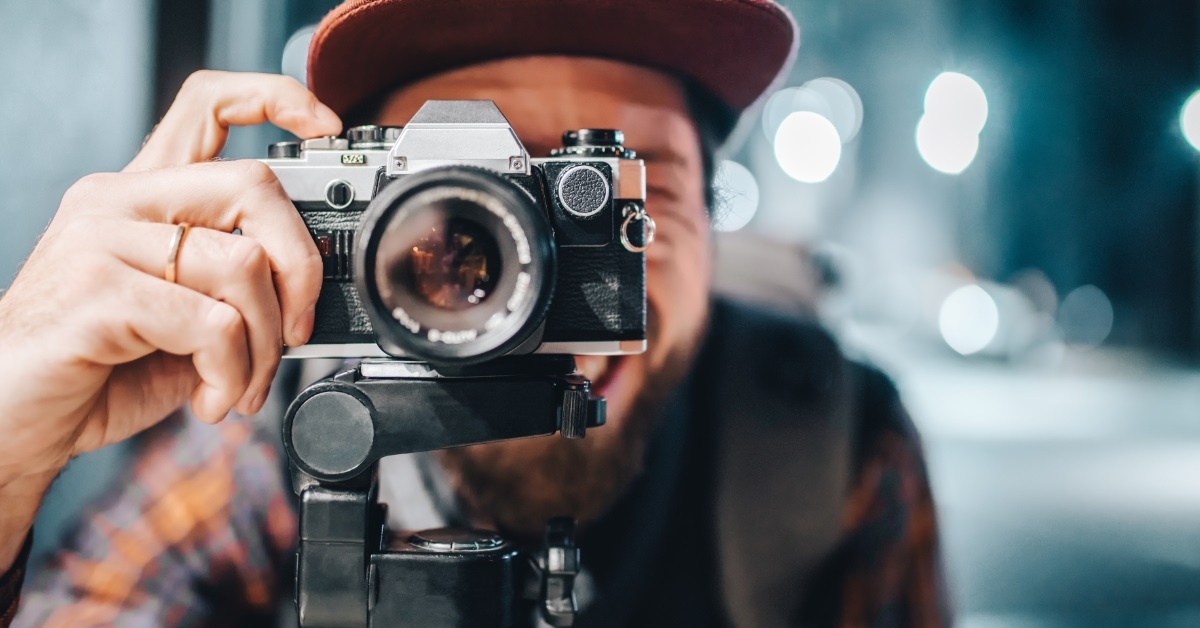 man taking photo using vintage camera