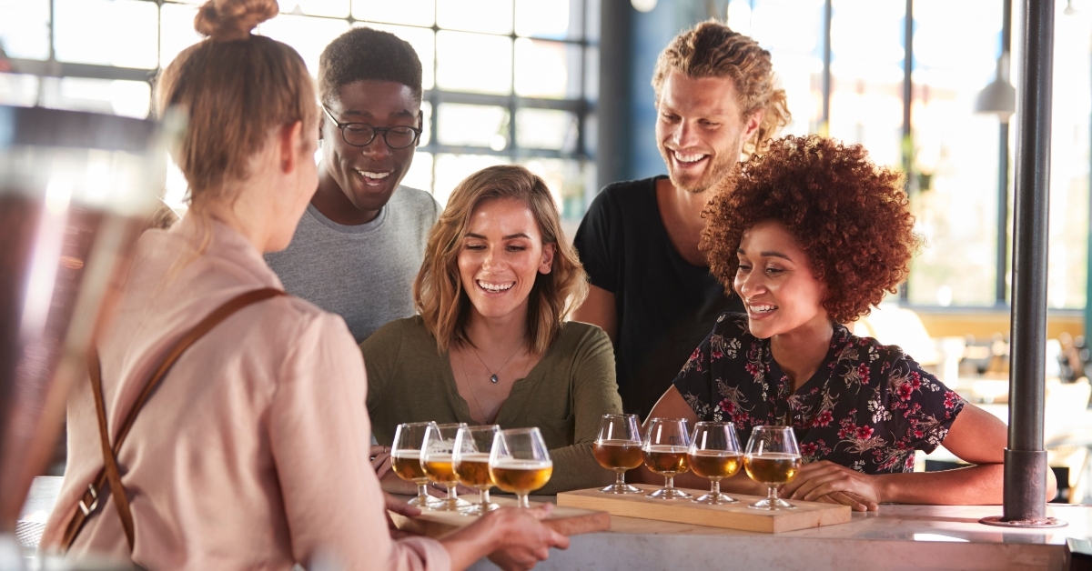 waitress serving group of friends beer