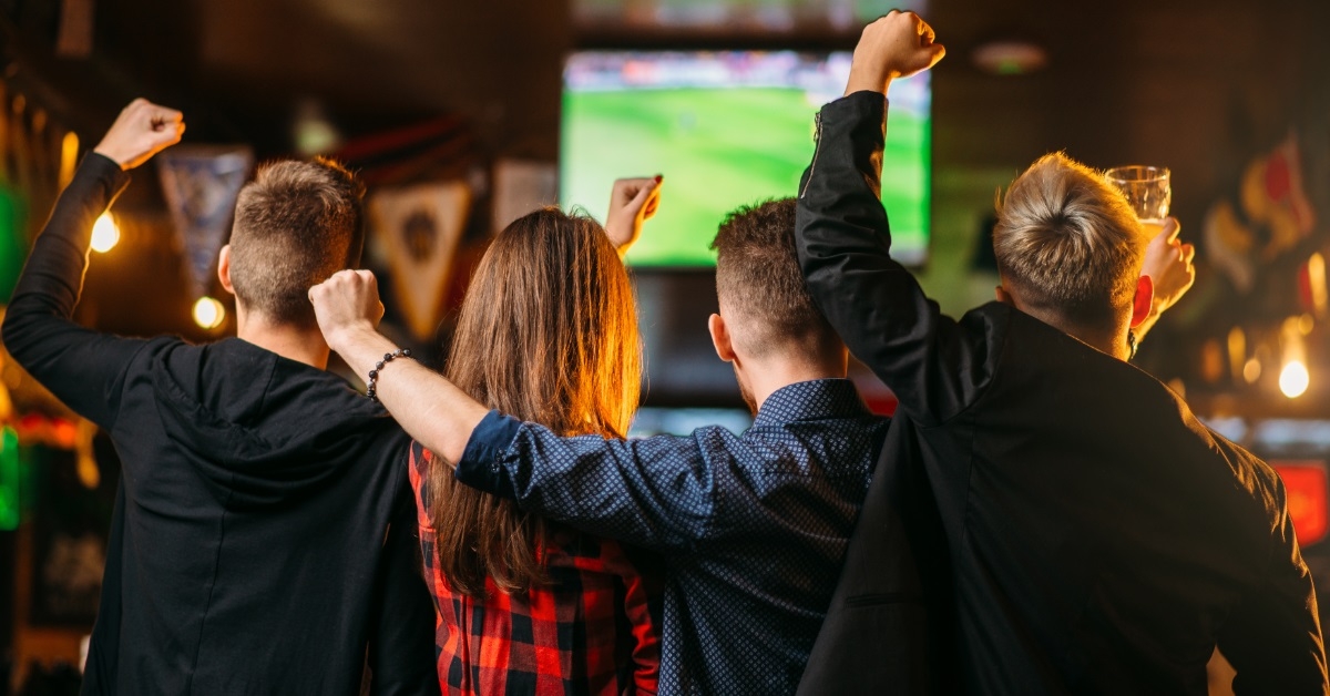 friends enjoying match at sports bar