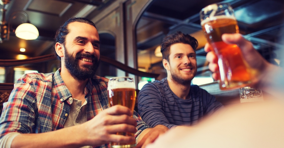 friends drinking beer at bar
