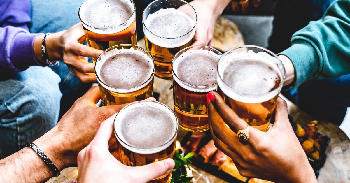 people cheering glass of beer