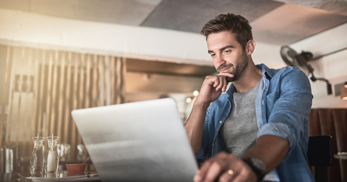 man doing research in a coffee shop