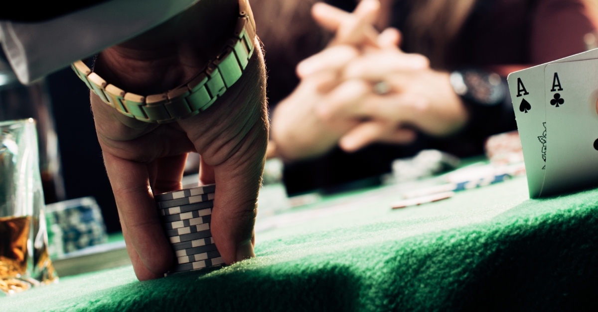 man touching playing cards