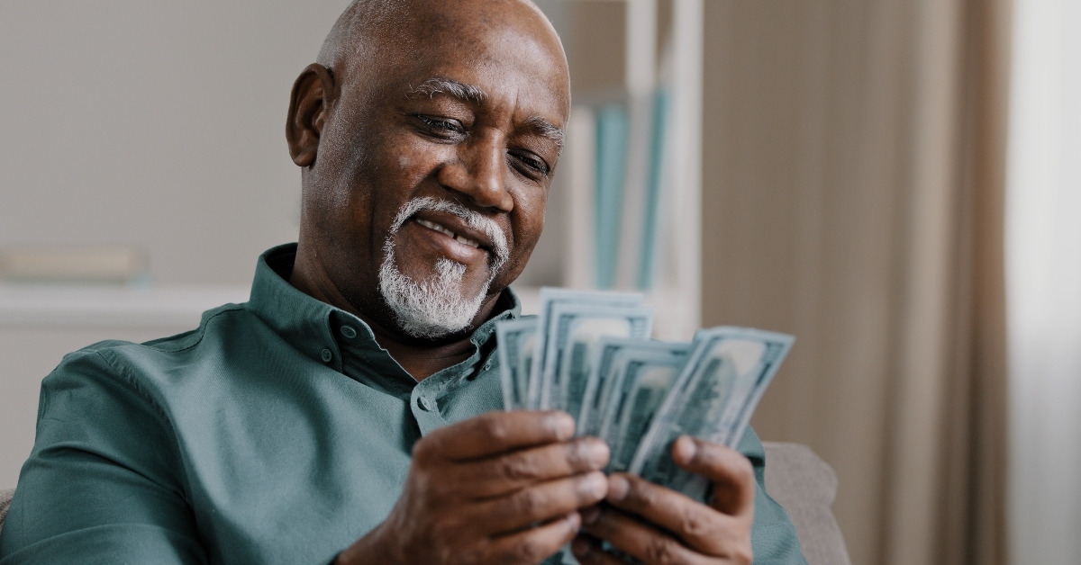senior man counting banknotes