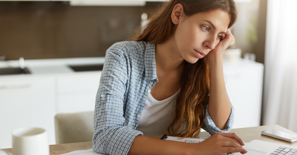 mature woman reviewing bills at home