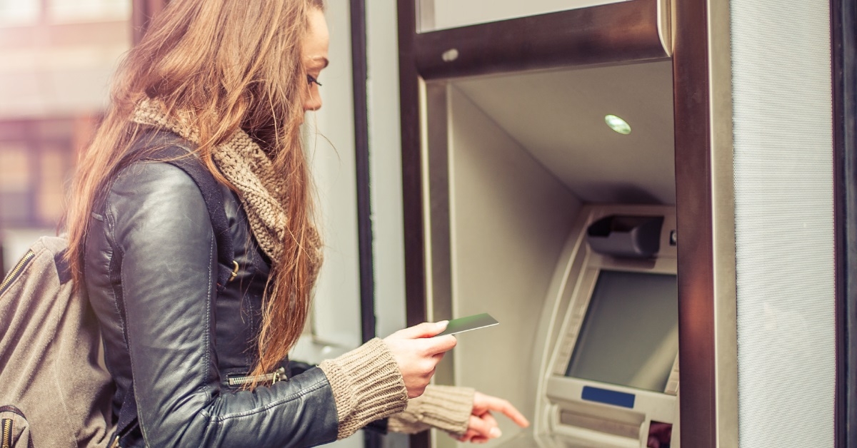 beautiful woman withdrawing money from atm