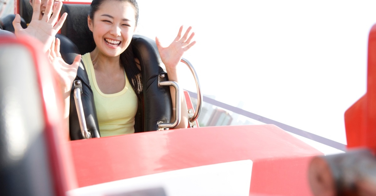 asian woman riding roller coaster