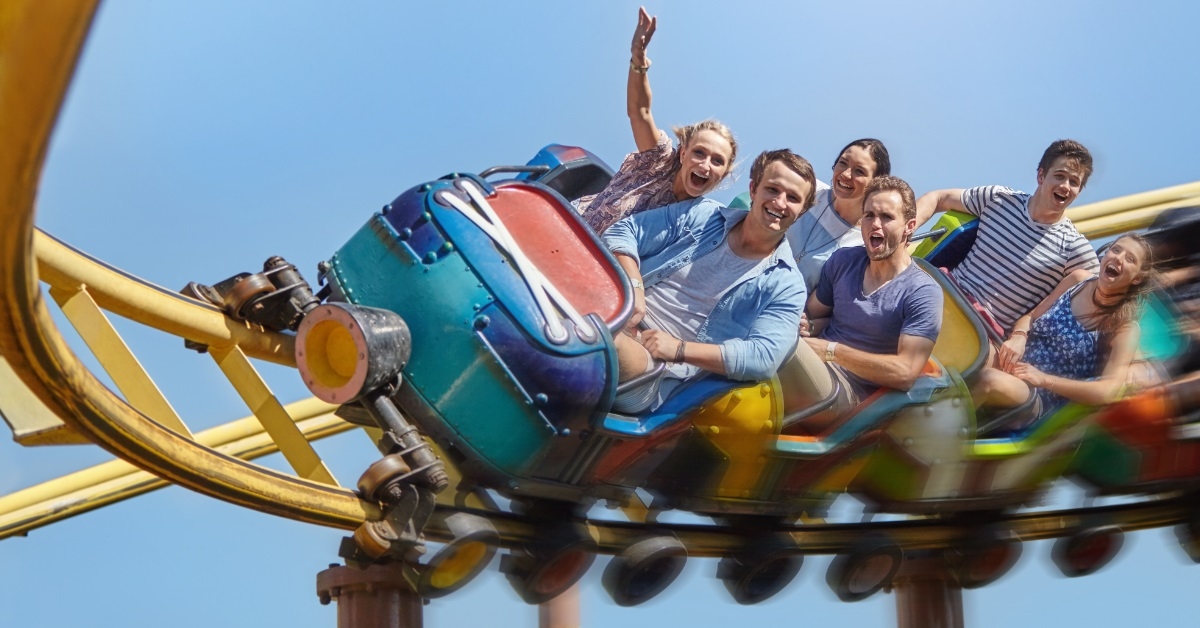 friends amused while riding roller coaster
