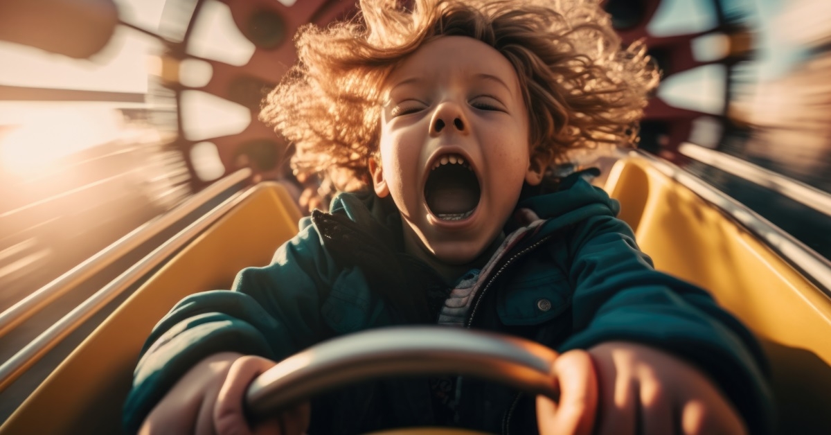 cute child riding fair roller coaster