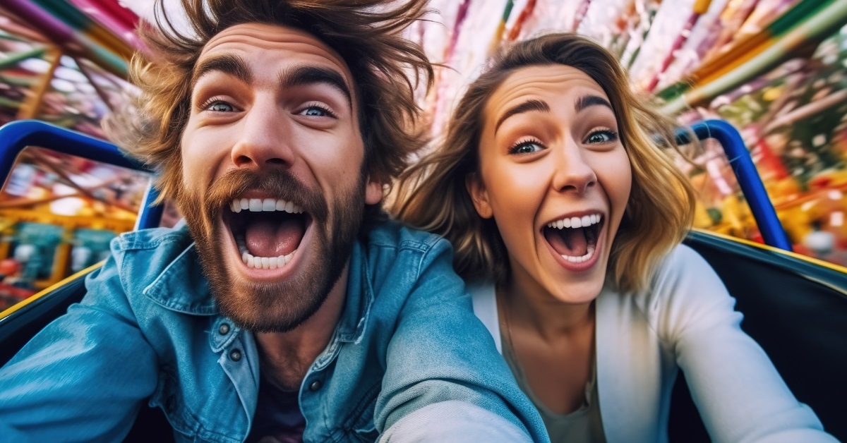 couple clicking selfie on roller coaster