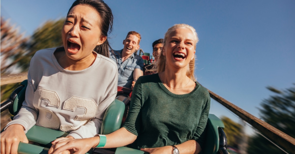 friends thrilled while riding roller coaster