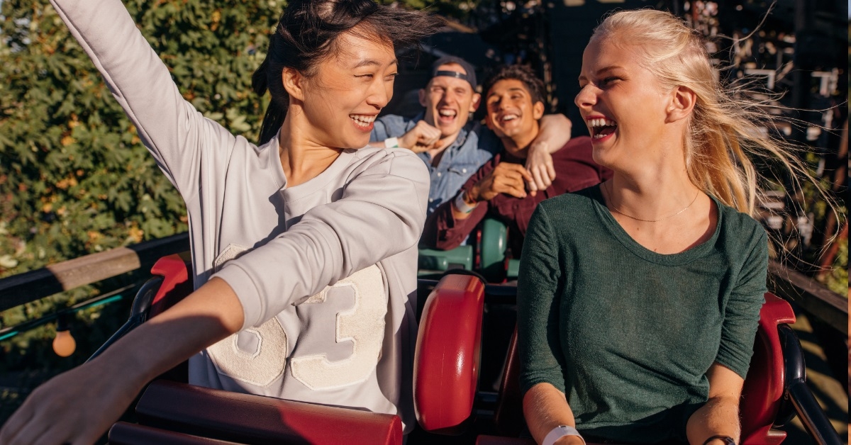 friends cheering on roller coaster ride