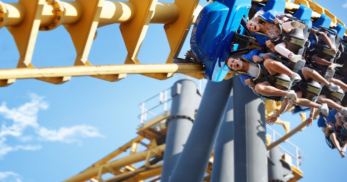 happy friends riding amusement park ride
