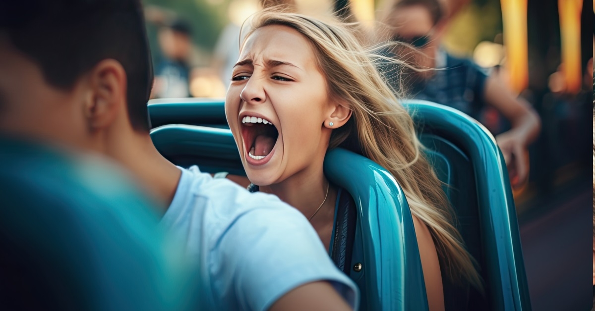 girl yelling while riding roller coaster