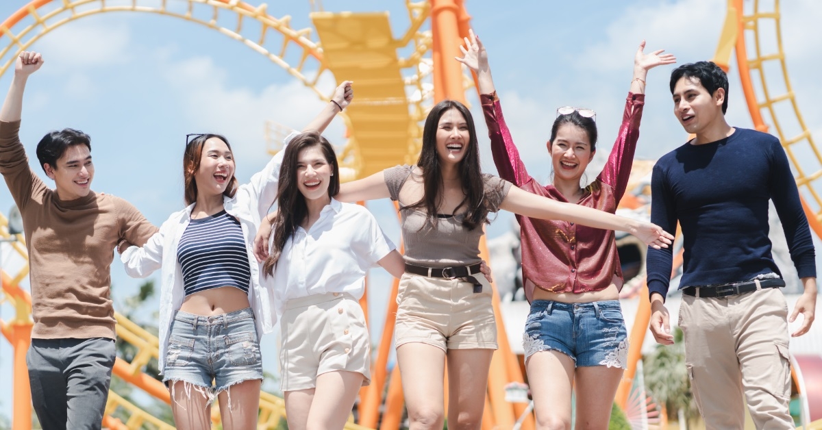 friends enjoying vacation at amusement park