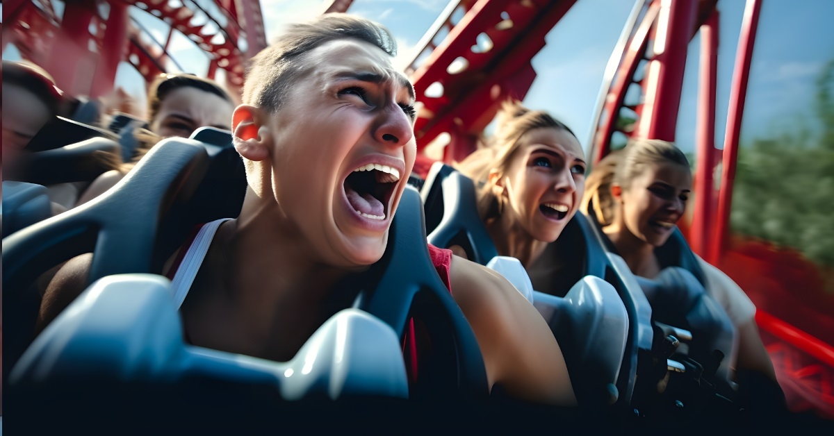 guy screaming while riding roller coaster