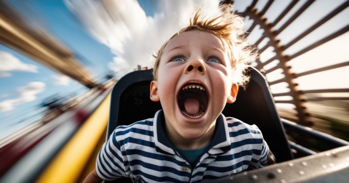 kid thrilled while riding roller coaster