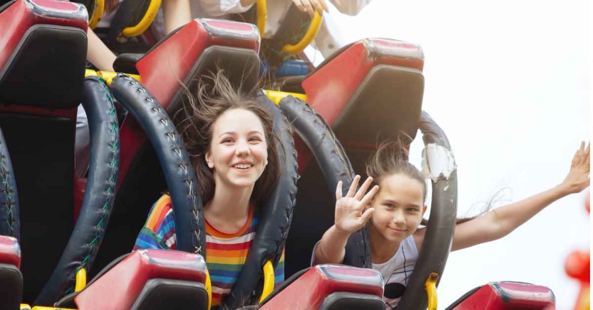 teen kids riding roller coaster