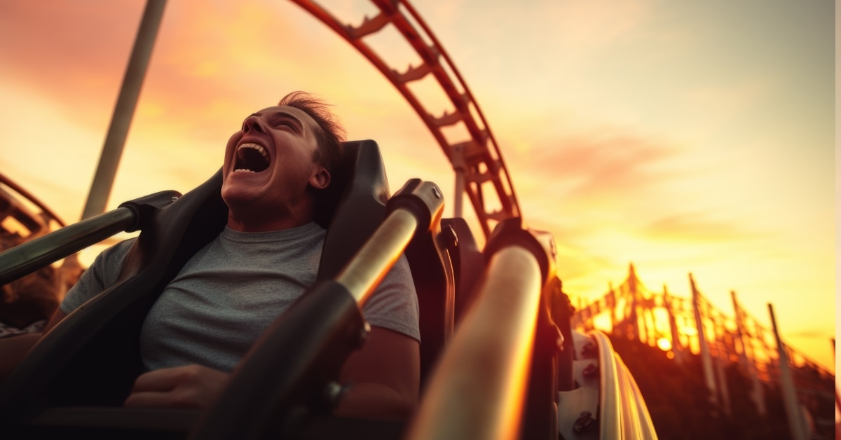 man yelling while riding roller coaster