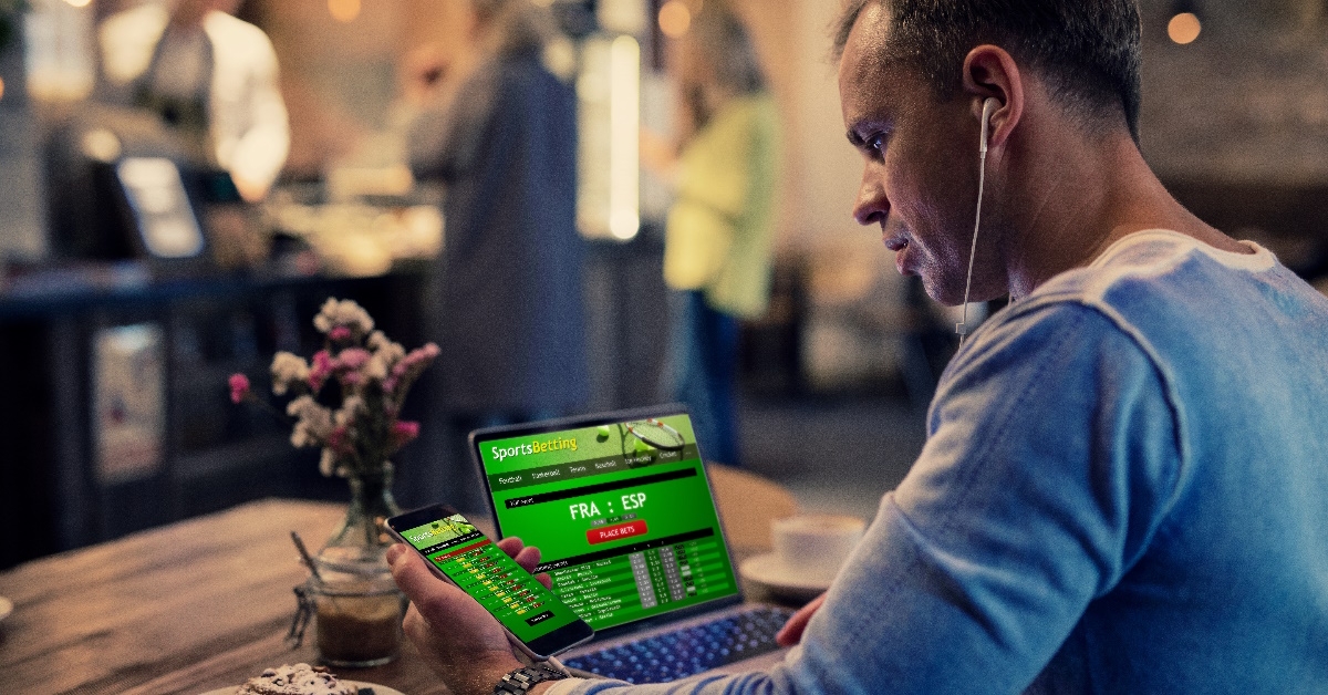 man using sports betting services online