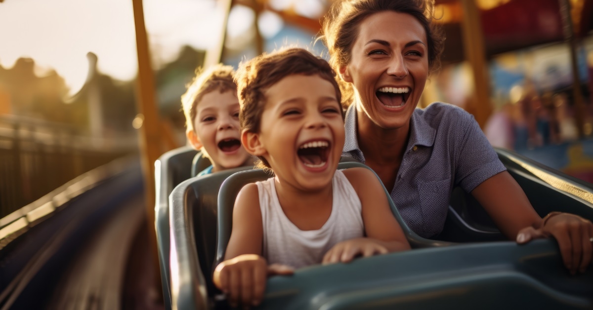 mother enjoying roller coaster with kids
