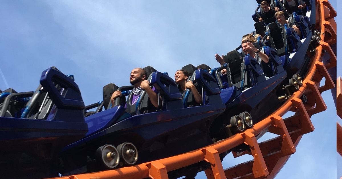 people riding roller coaster trolleys