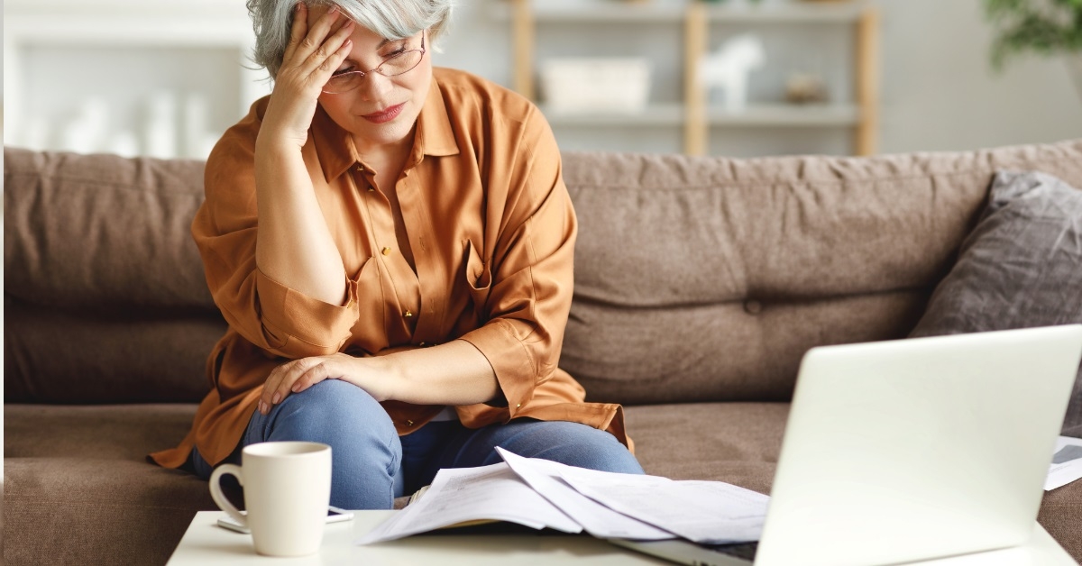 Lady looking worried while reading a document.