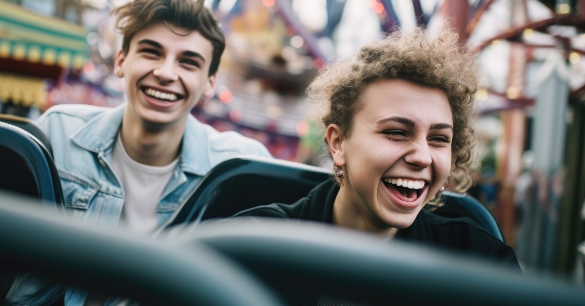 teenage friends riding roller coaster