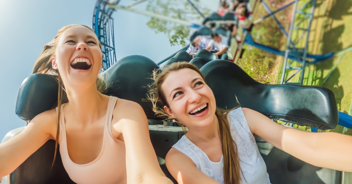 girl friends enjoying roller coaster ride