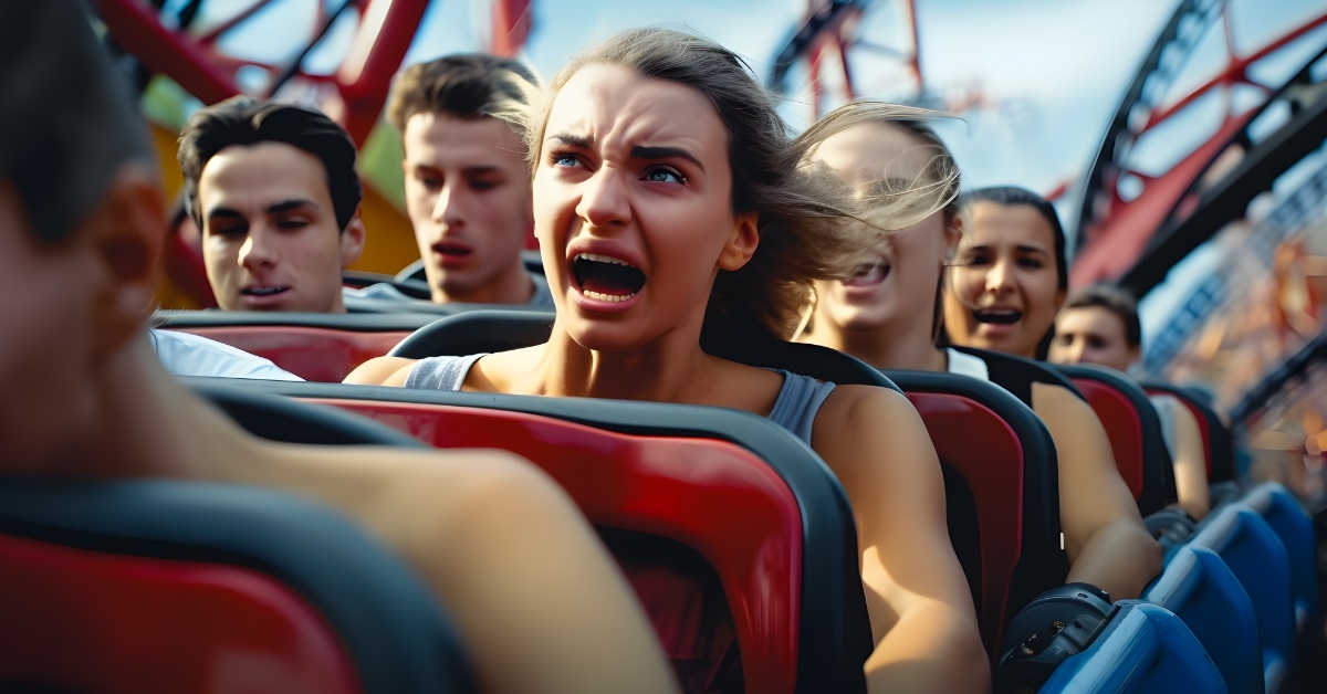 woman scared while riding roller coaster