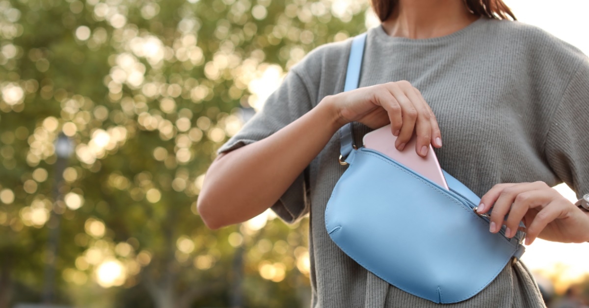 woman keeping smartphone in bag