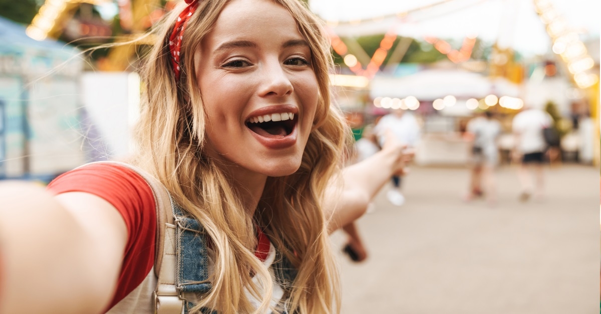 woman taking selfie at amusement park