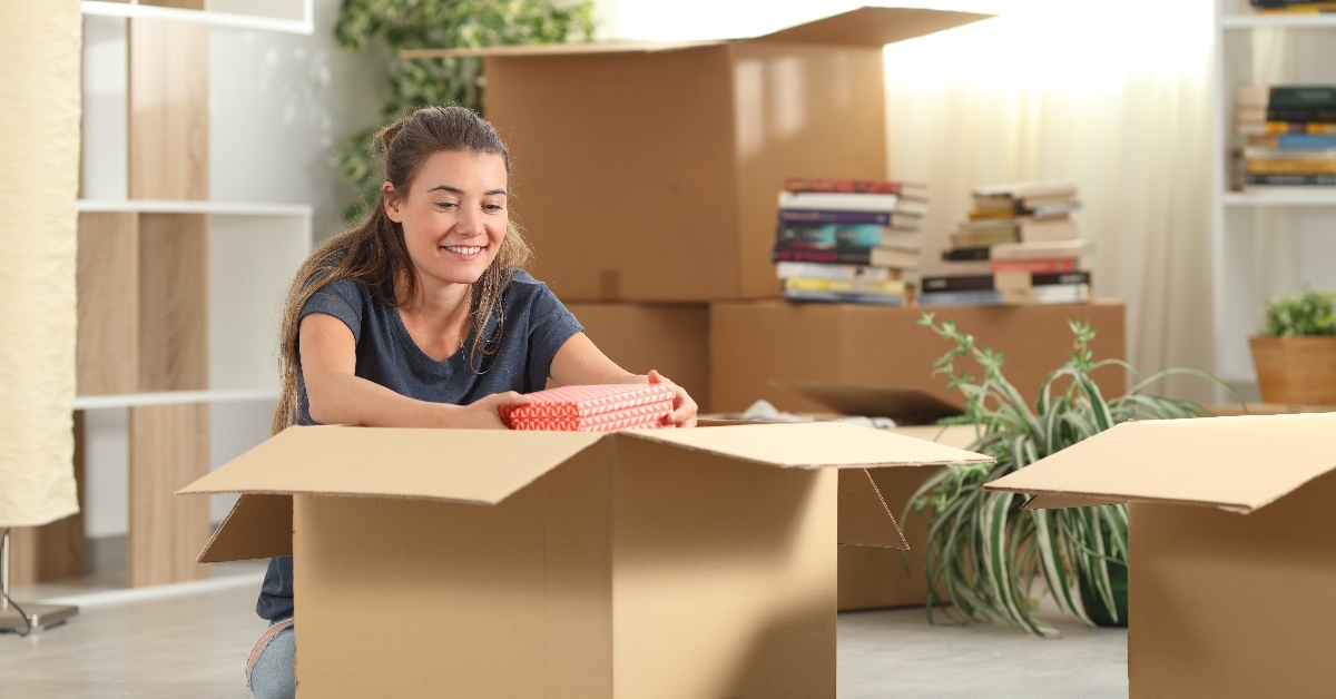 young women unpacking boxes at home