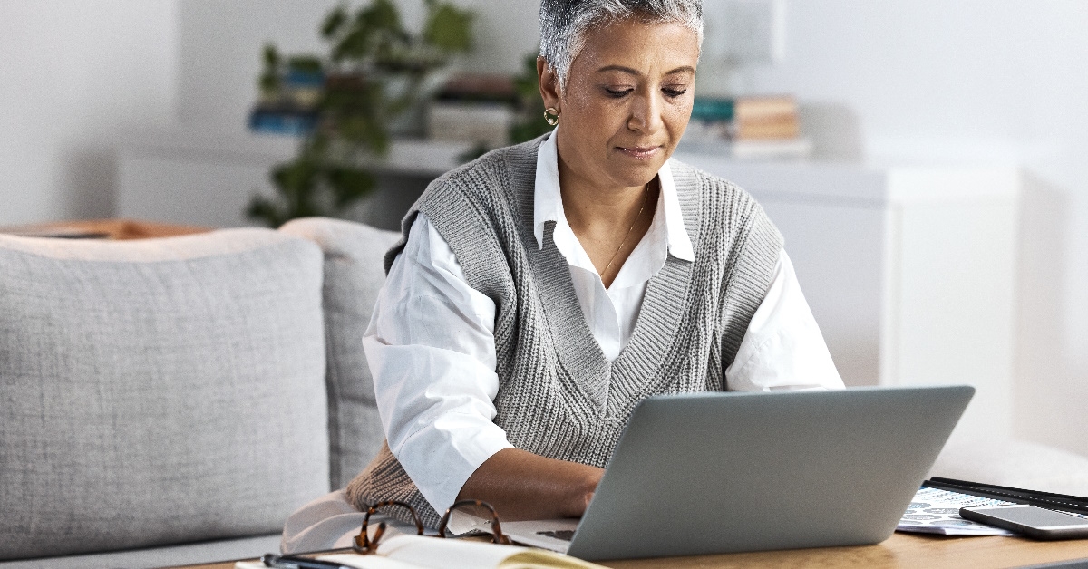 Businesswoman diligently operating her laptop.
