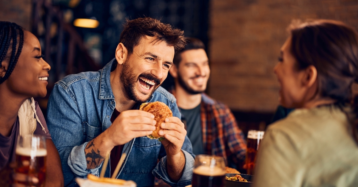 happy man eats burger