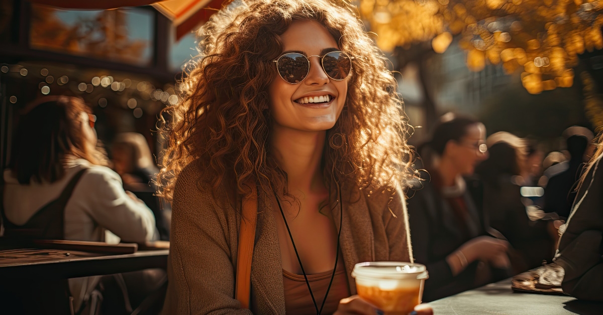 Woman enjoying Pumpkin Spice Latte.