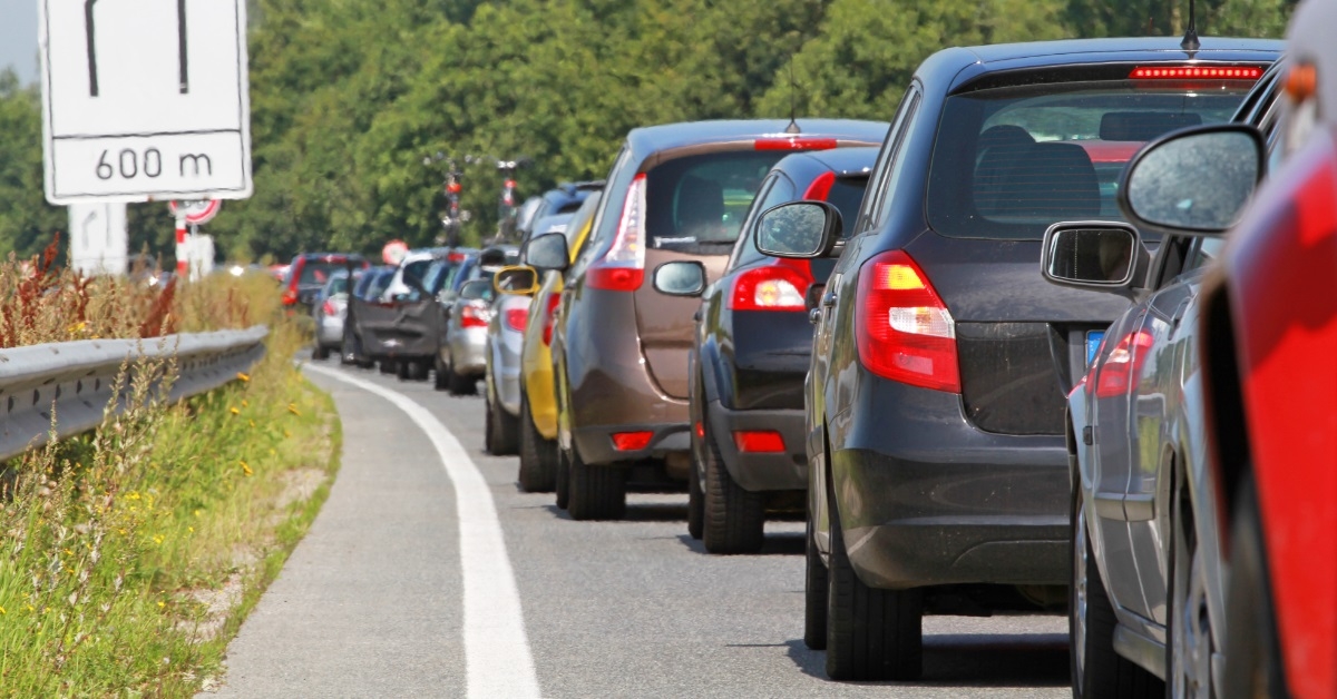 cars waiting in traffic in sun