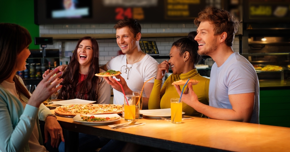 friends having fun eating pizza