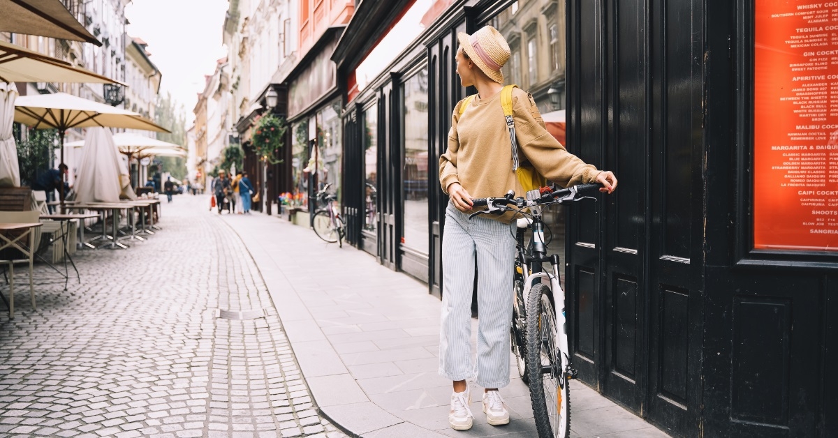 female tourist exploring city on bicycle