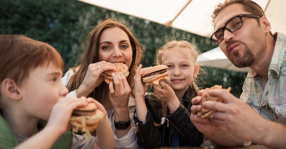 happy family eating burgers